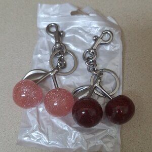 TWO HAND BAG CHERRY CHARMS.